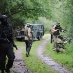 Airsofters advancing down a path
