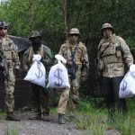 Airsoft playters holding game assets