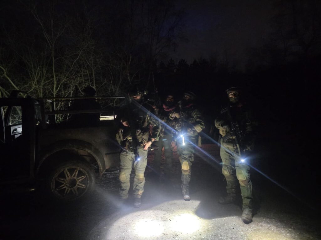 Four airsoft players and a vehicle on a night vision game at The Kingdom