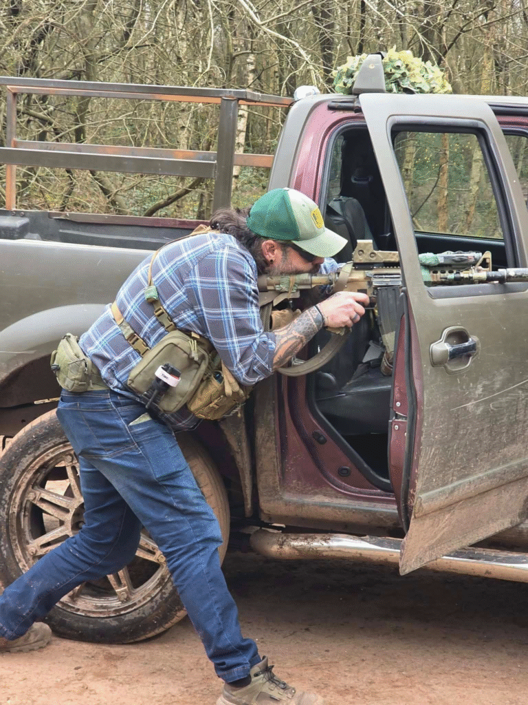 Airsoft player at an open vehicle door at The Kingdom
