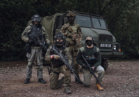 Group of airsoft players with a Jeep at The Kingdom woodland airsoft site, Staffordshire