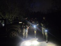 Four airsoft players and a vehicle on a night vision game at The Kingdom