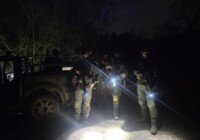 Four airsoft players and a vehicle on a night vision game at The Kingdom