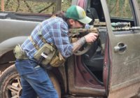 Airsoft player at an open vehicle door at The Kingdom