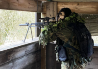 Airsoft sniper taking position in a window at The Kingdom