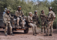 Six MilSim airsoft players beside a Land Rover at The Kingdom, Staffordshire